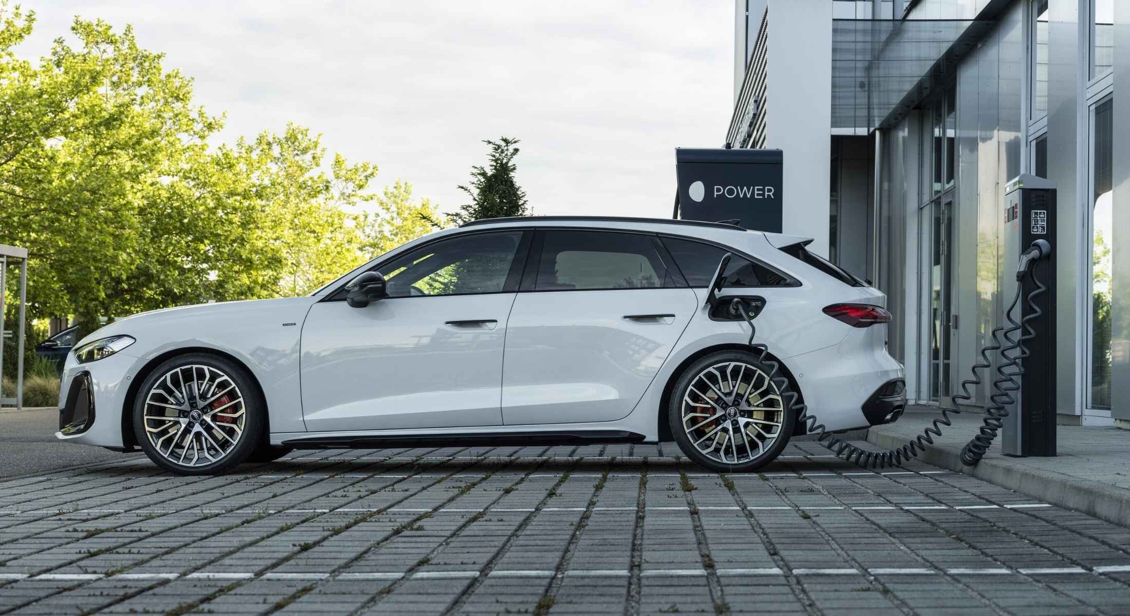 Ein weißer Audi angesteckt an einer Ladesäule